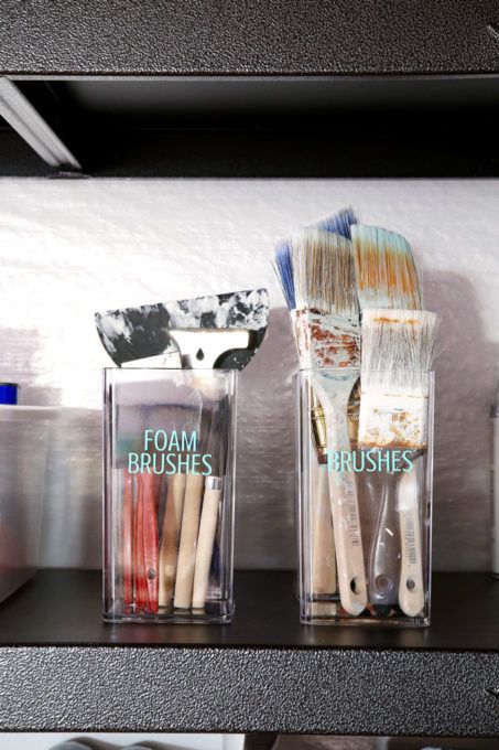 three plastic containers with toothbrushes and toothpaste in them on a shelf