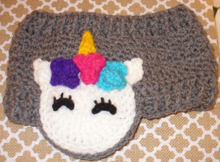 a crocheted hat with a unicorn's face on it