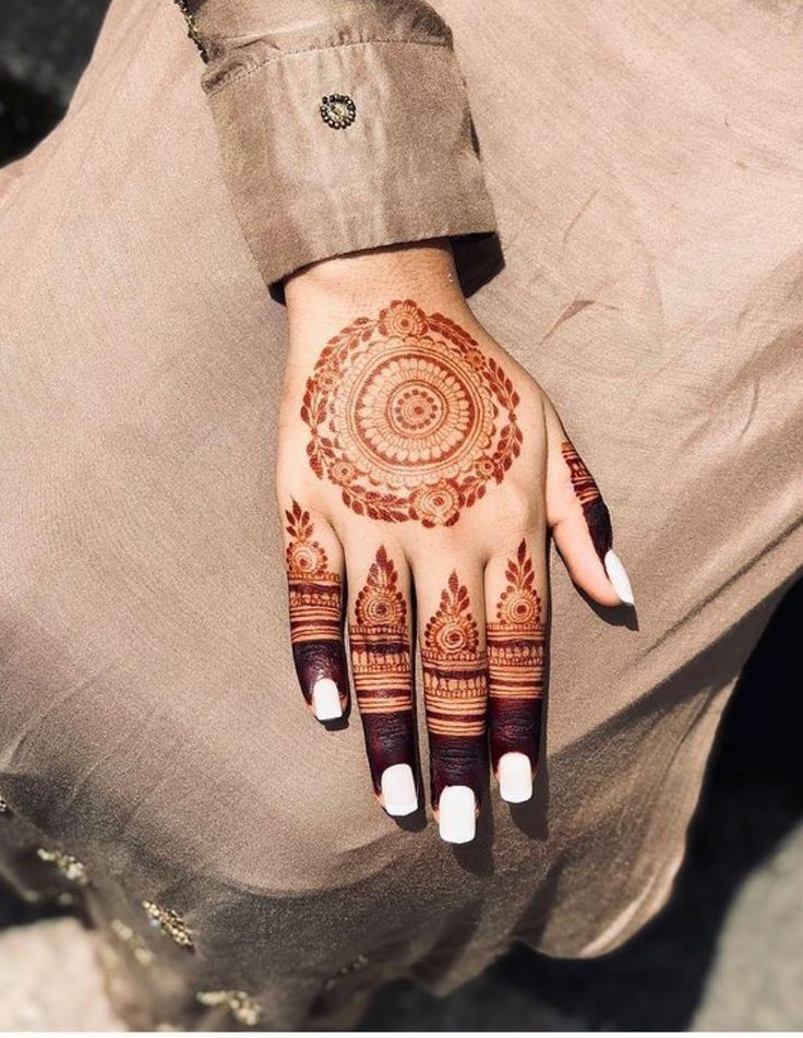 a woman's hand with hennap on it and her hands in the shape of a circle