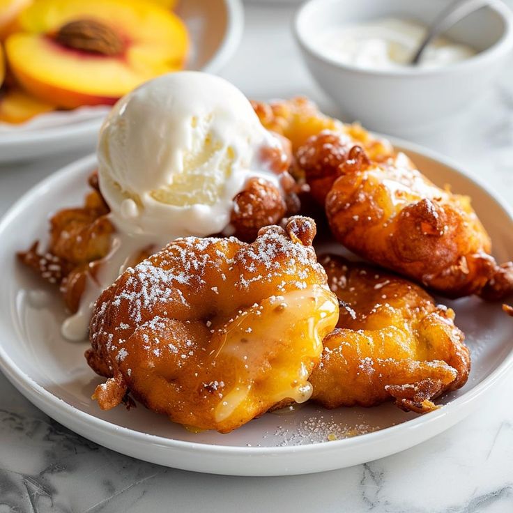 a white plate topped with dessert next to bowls of ice cream and peaches on a table