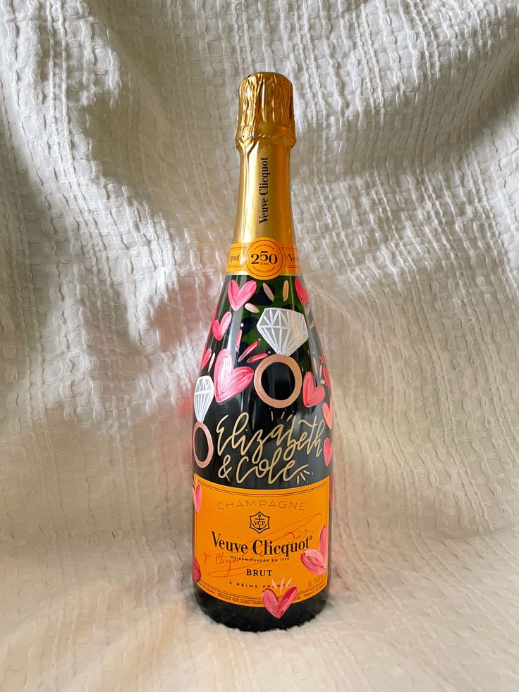 a bottle of champagne sitting on top of a white cloth