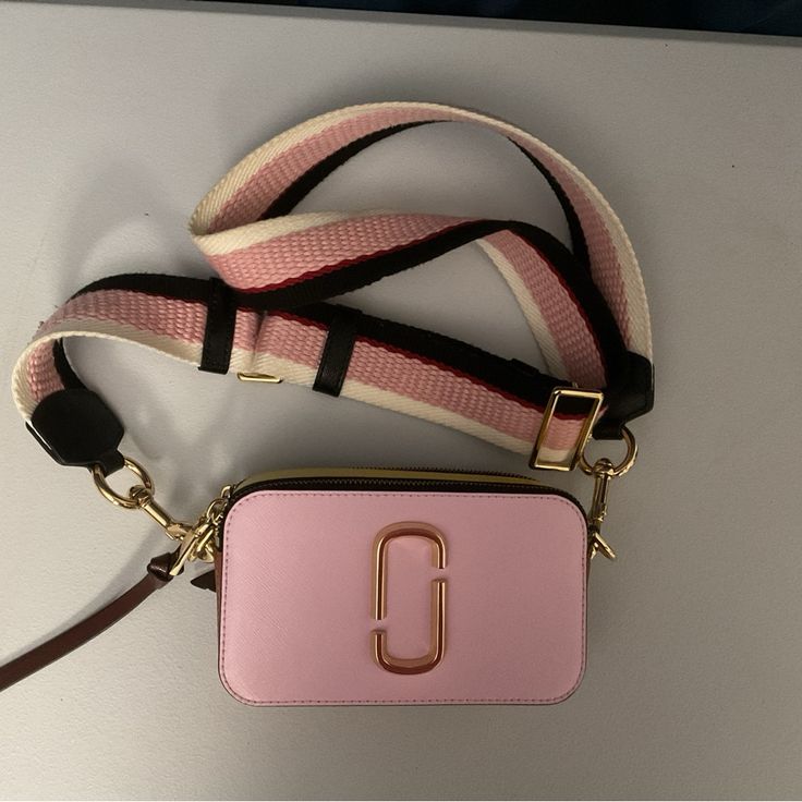 Brand New The Marc Jacob’s Snapshot Bag. No Scuffs Or Marks. Adjustable Strap. Super Cute For Spring And Summer Pink Bags With Logo Strap For Everyday, Pink Everyday Bag With Logo Strap, Gold Bag With Logo Strap For Everyday Use, Pink Crossbody Bag With Strap, Pink Rectangular Bag With Strap, Pink Travel Bag With Strap, Pink Detachable Crossbody Bag Strap, Pink Detachable Bag Strap, Luxury Gold Bag With Strap