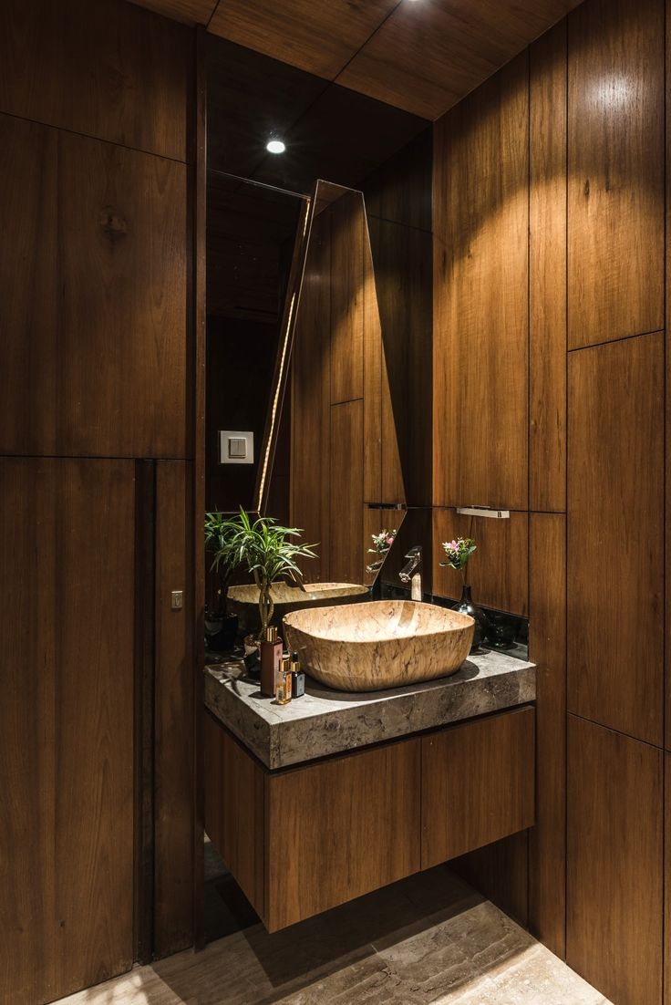 a bathroom with wooden walls and a sink