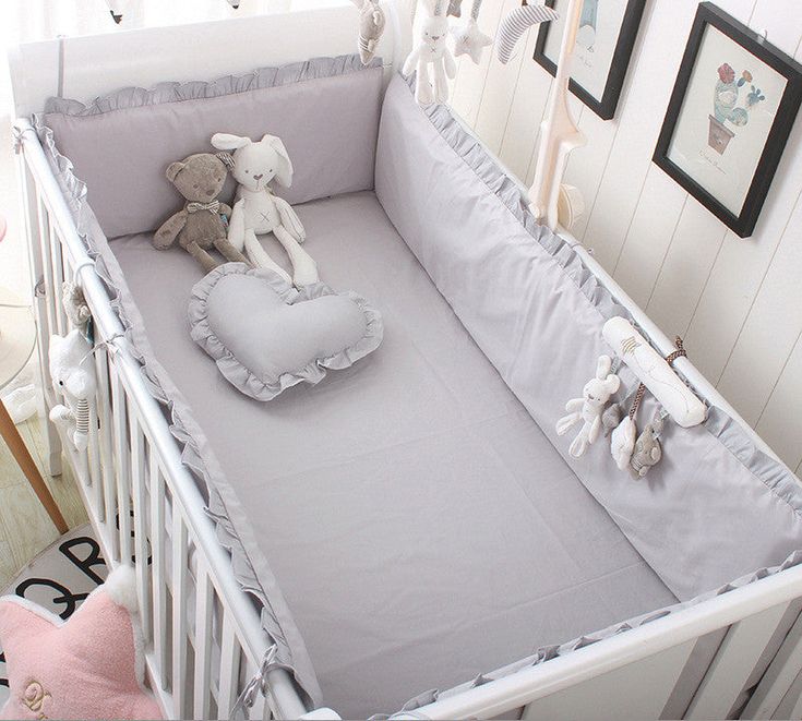 a baby crib with a stuffed animal in it