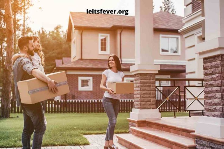 a man and woman carrying boxes in front of a house with the sun shining on them