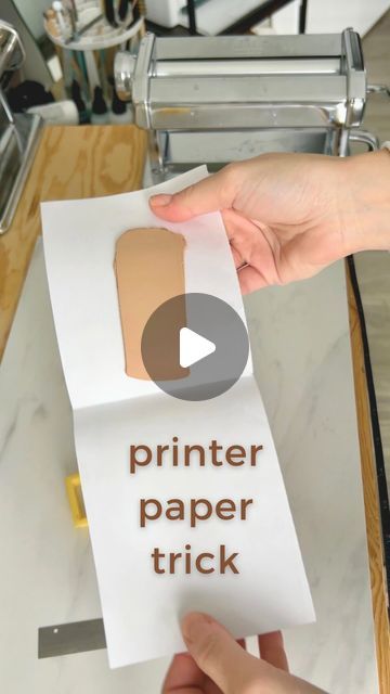 a person holding a piece of paper with the words printer paper trick on it