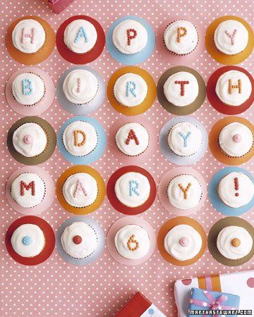 cupcakes with the words happy on them are arranged in rows against a pink background