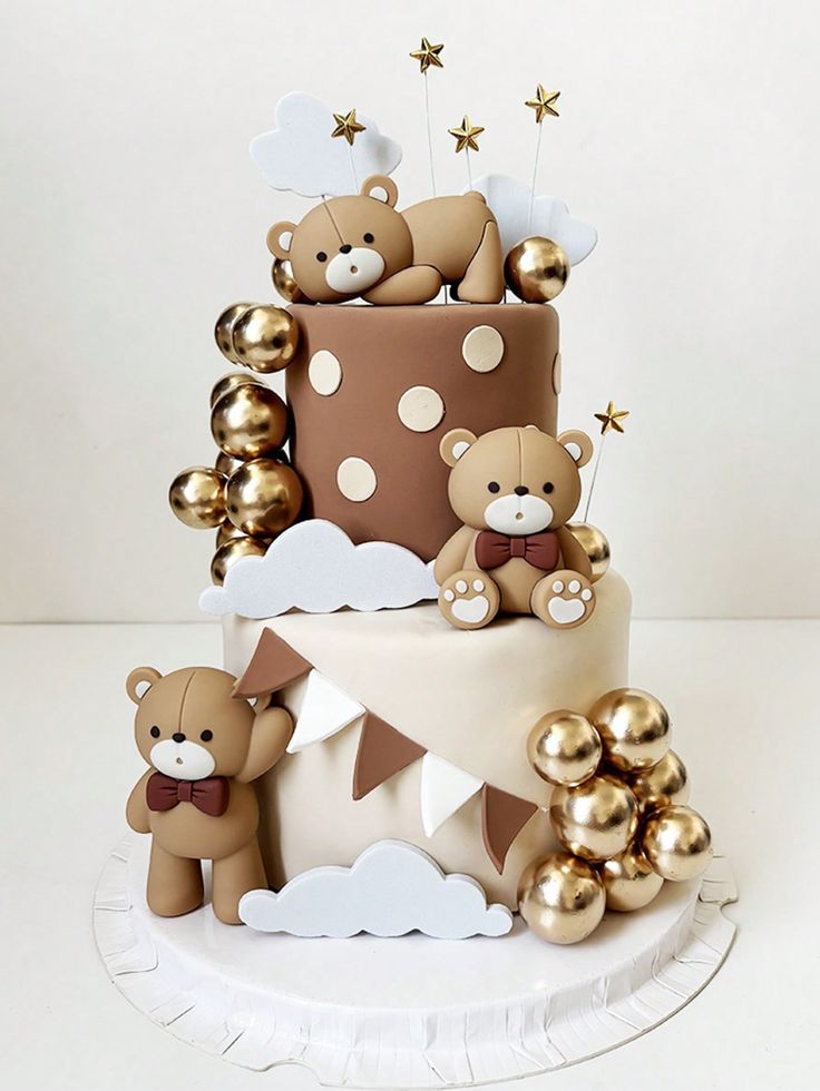 a three tiered cake decorated with teddy bears and gold foil balloons, on top of a white plate