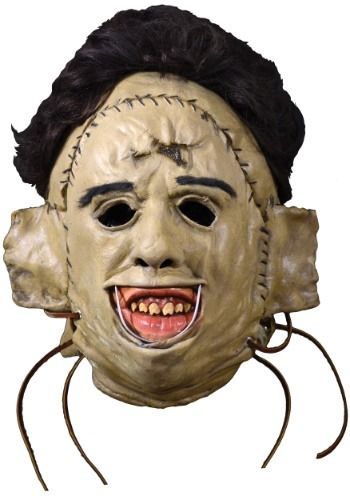 a creepy mask with black hair and teeth