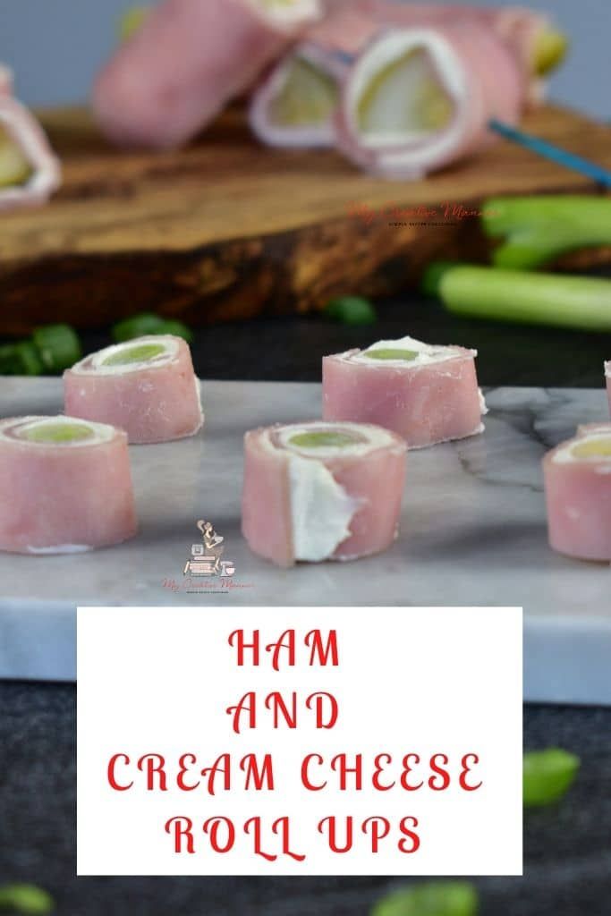 ham and cream cheese rolls on a cutting board with chopsticks next to them