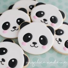 cookies decorated like panda bears on a table