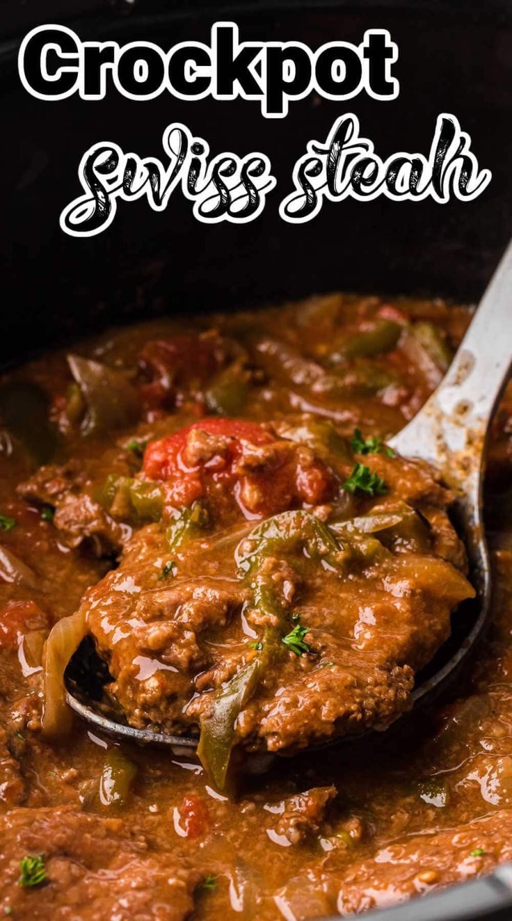 a close up of a spoon with some food in it and the words crockpot swiss steak