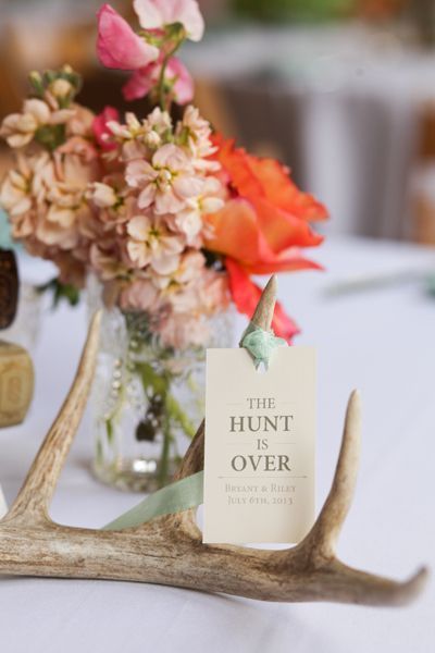 an image of a table setting with deer antlers and place cards on the table