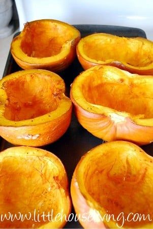 several peeled pumpkins sitting on top of a baking sheet in the oven, ready to be cooked