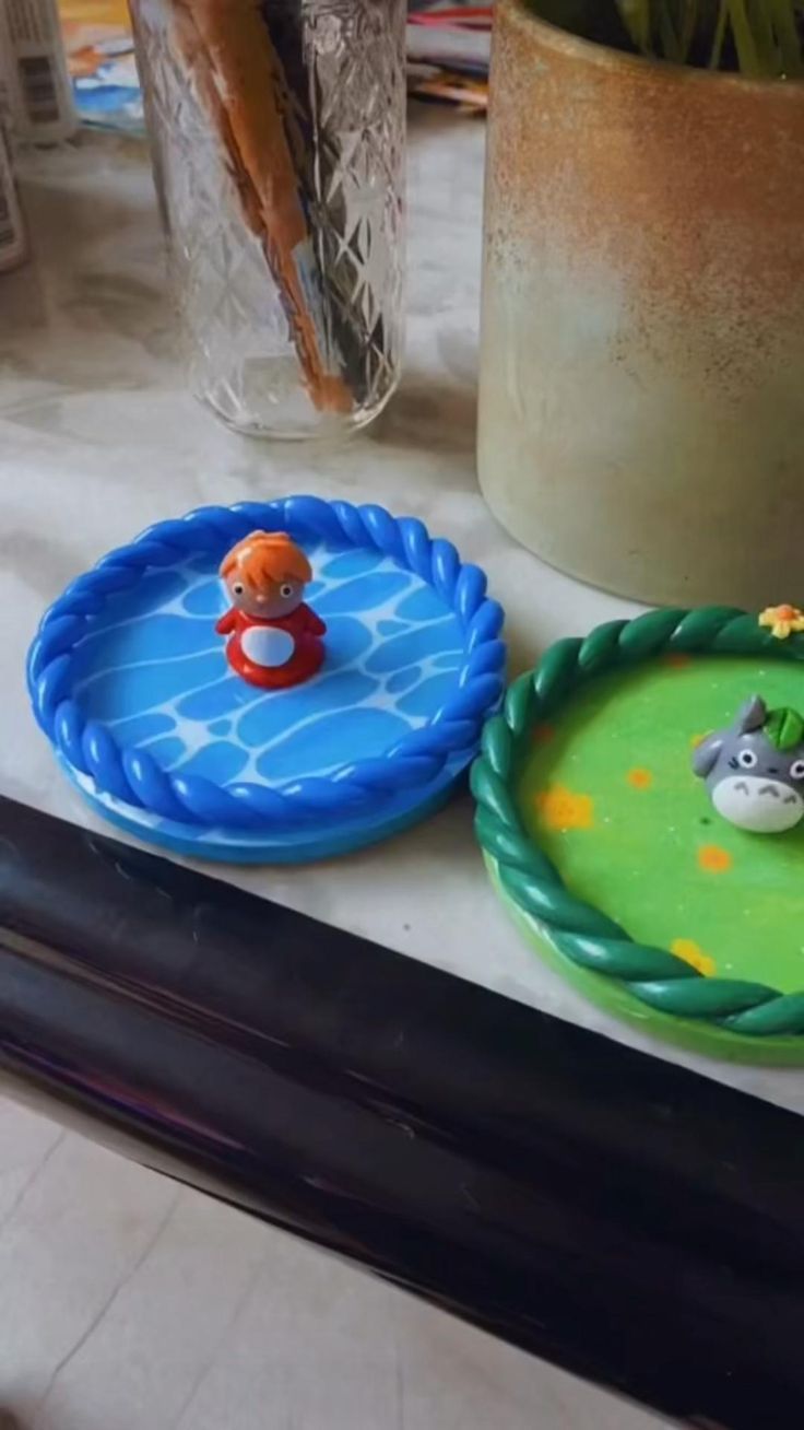 three plastic plates sitting on top of a table