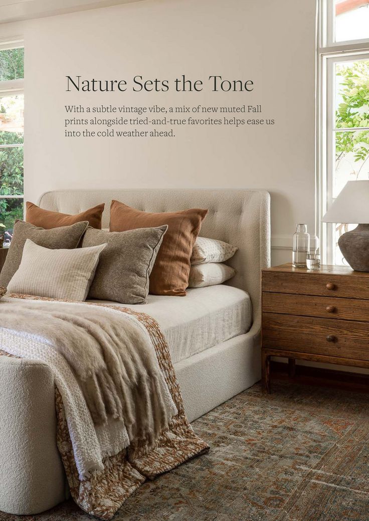 there is a bed with many pillows on it in the room that says nature sets the tone