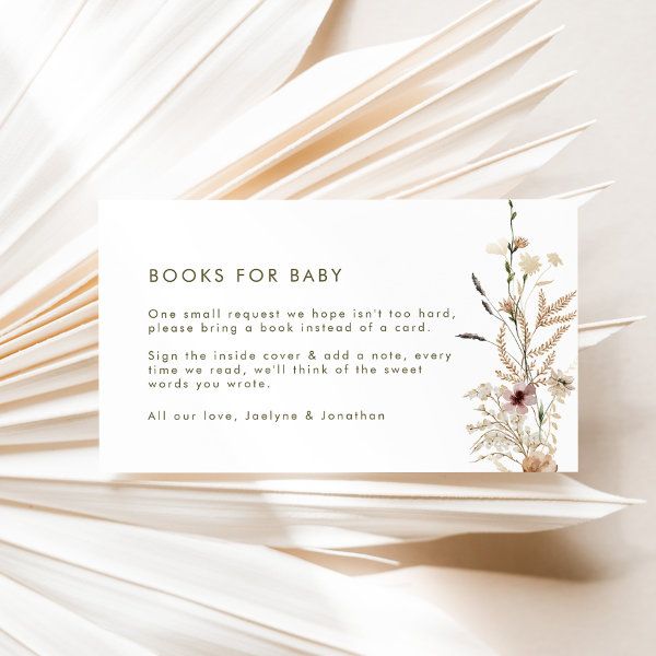 an open book with the words books for baby written on it and flowers in front