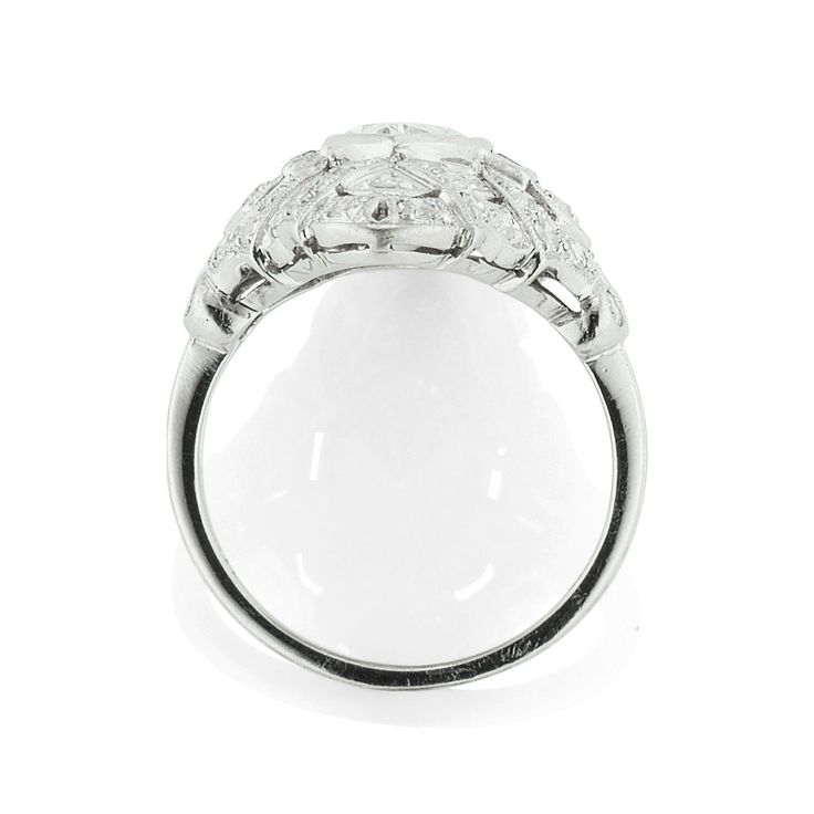 a white gold ring with diamonds on the sides and an oval shaped diamond in the center