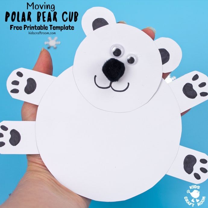 a hand holding up a polar bear cutout with black and white paw prints on it