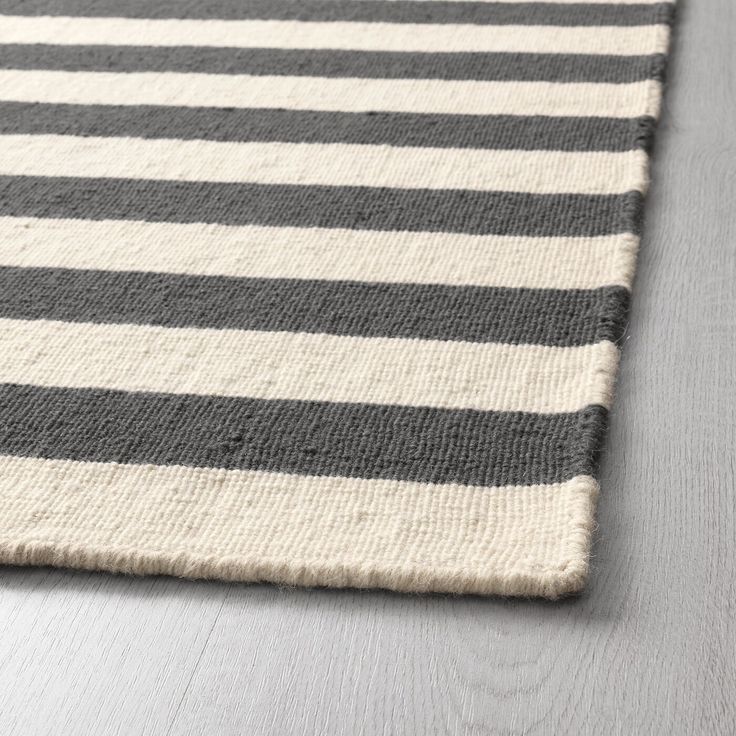 a black and white striped rug on the floor