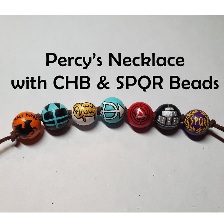 a row of beads with the words percy's necklace with chb & spor beads