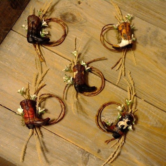 four pieces of cowgirl's boots and flowers are arranged on a wooden table