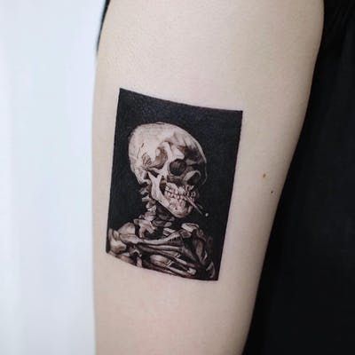 a woman with a skull tattoo on her arm