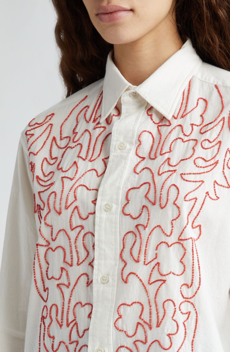 Inspired by vintage embroidery, this cotton button-up shirt is detailed with bright red beads arranged in a vine-like design. 29" front length; 31" back length (size Medium) Front button closure Point collar Long sleeves with button cuffs 100% cotton Dry clean Imported Designer Clothing Amazing Embroidery Designs, Embroidery White Shirt, Embroidery Designs With Beads, Collar Embroidery Design, Free Motion Embroidery Designs, Embroidery Outfits, Random Embroidery, Beads Shirt, Embroidery On Shirt