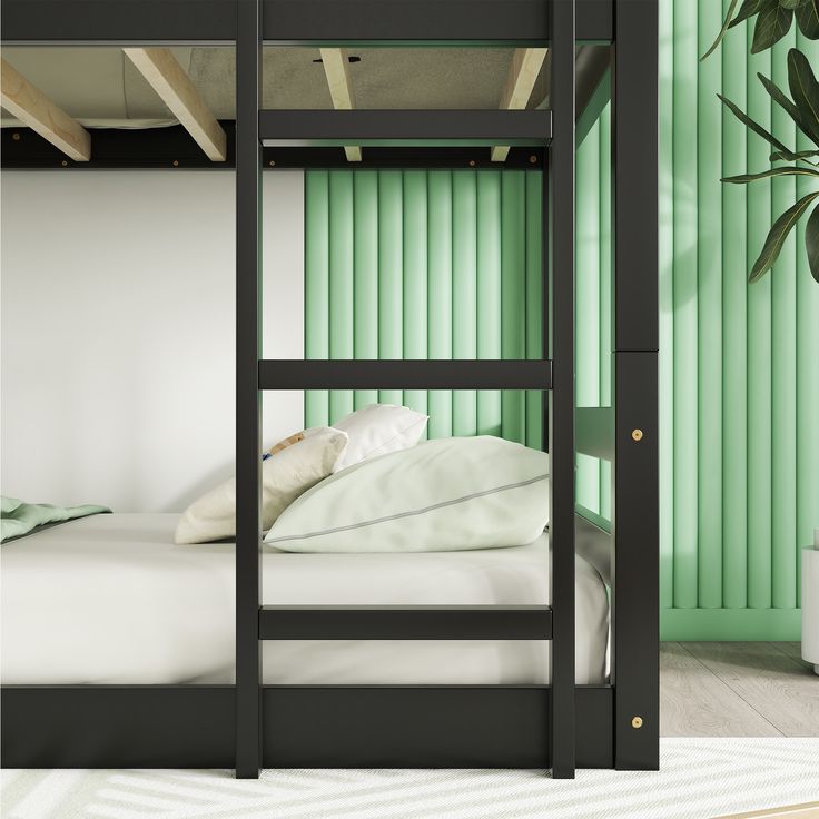 a black bunk bed sitting next to a green wall with white sheets and pillows on it