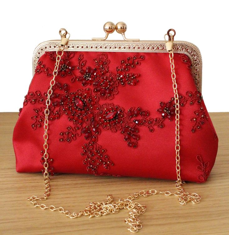 The Red beaded Wedding clutch bag and Red beaded Evening Bag are a unique piece of the Olga's Luxury Creation.  100% Handmade bag with Haute couture fabric and lace fabric. Designer embroidery bag for Wedding day. Our collection of Bridal purse and Wedding clutch bag made in France.  They will sublimate you during your galas, parties and events. Elegance, style and originality are the key parts of these creations. The use of quality materials, advanced know-how are essential values to offer you Luxury Red Elegant Clutch, Affordable Red Elegant Evening Bag, Luxury Elegant Red Clutch, Luxury Red Wedding Clutch, Trendy Luxury Evening Bag For Gift, Luxury Evening Bags With Crystal Embellishments, Luxury Elegant Evening Bag With Pearl Embroidery, Trendy Luxury Evening Bag As Gift, Luxury Pearl Embroidery Bag For Gift