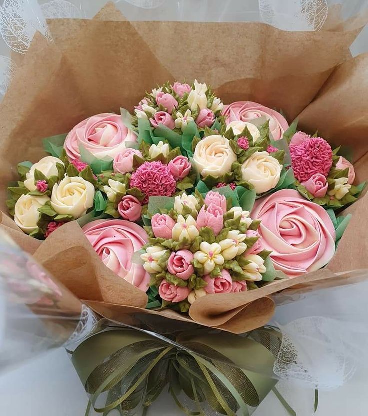 a bouquet of pink and white flowers sitting on top of a table