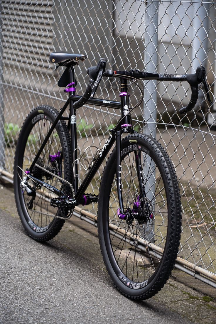 a bike leaning against a chain link fence