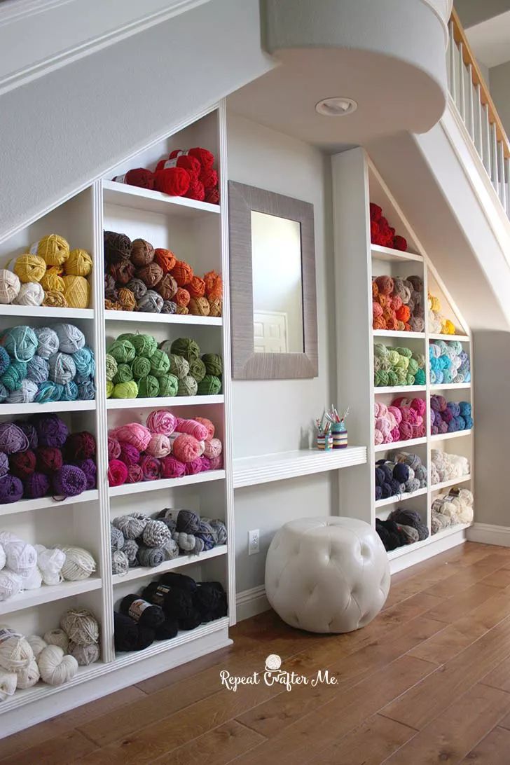 there are many balls of yarn on the shelves next to each other in this room