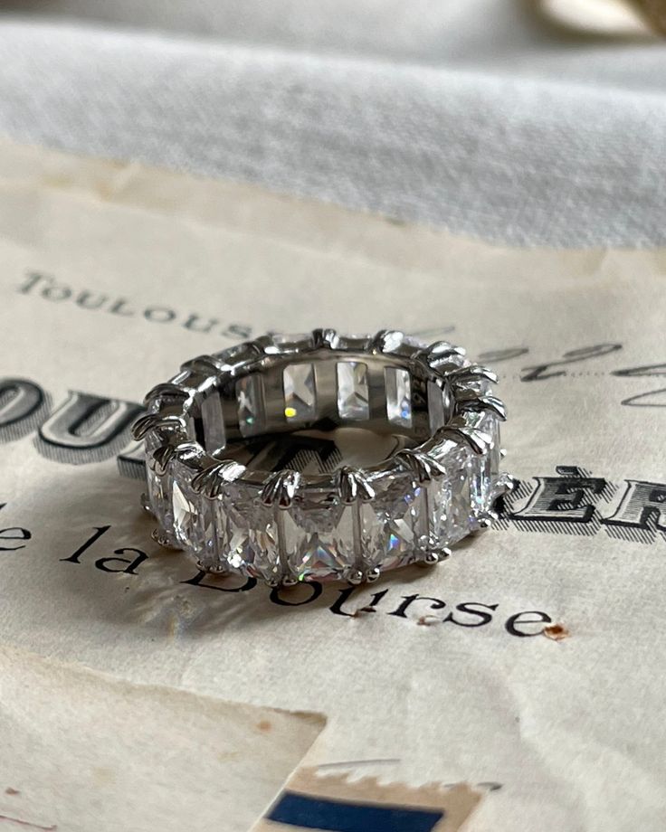 Get your sparkle on with the Rêvasser Ring—a diamond eternity ring to make all your friends say “ooh-la-la”! Strut about town in that subtle-but-glamorous way you do, and bask in the compliments this dazzling piece of jewelry will bring you. Rêvasser Ring means Daydream in French. This dreamy stackable ring is prefect to add to your collection. Cubic Zirconia 4x6mm set in silver. Dazzling Diamond White Eternity Band Promise Ring, Cubic Zirconia Emerald Cut Half Eternity Ring, Cubic Zirconia Radiant Cut Half Eternity Jewelry, Promise Eternity Band With Diamond Accents In Cubic Zirconia, Emerald Cut Cubic Zirconia Half Eternity Ring, Silver Jewelry With Half Eternity Baguette Cut, Silver Radiant Cut Half Eternity Jewelry, Diamond White Cubic Zirconia Eternity Band For Promise, Silver Baguette Cut Eternity Band Promise Ring