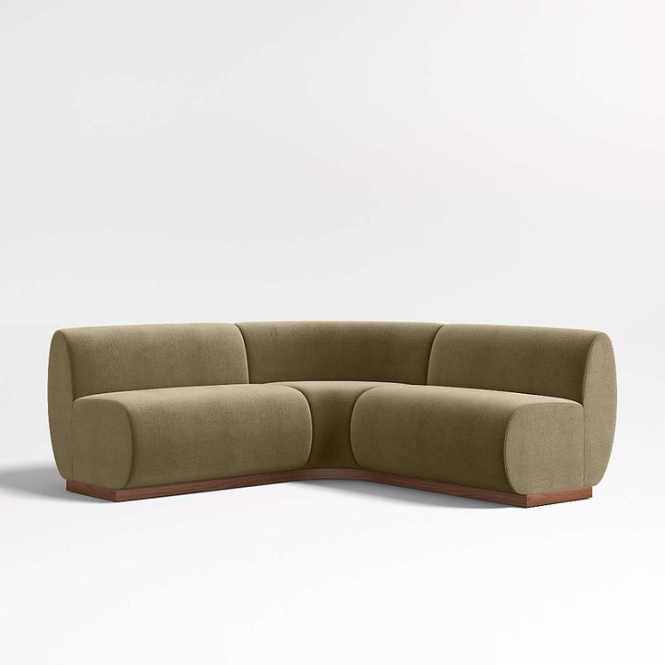 the curved sectional sofa is made out of fabric and has two arms that are connected to each other