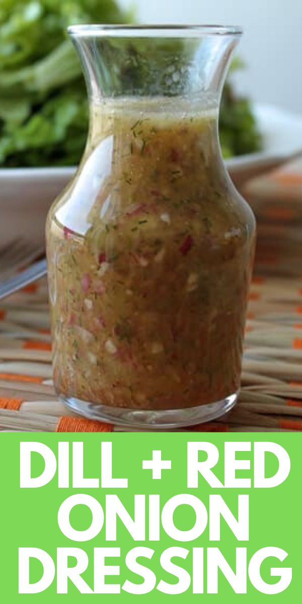 an image of dill and red onion dressing in a glass jar on a table