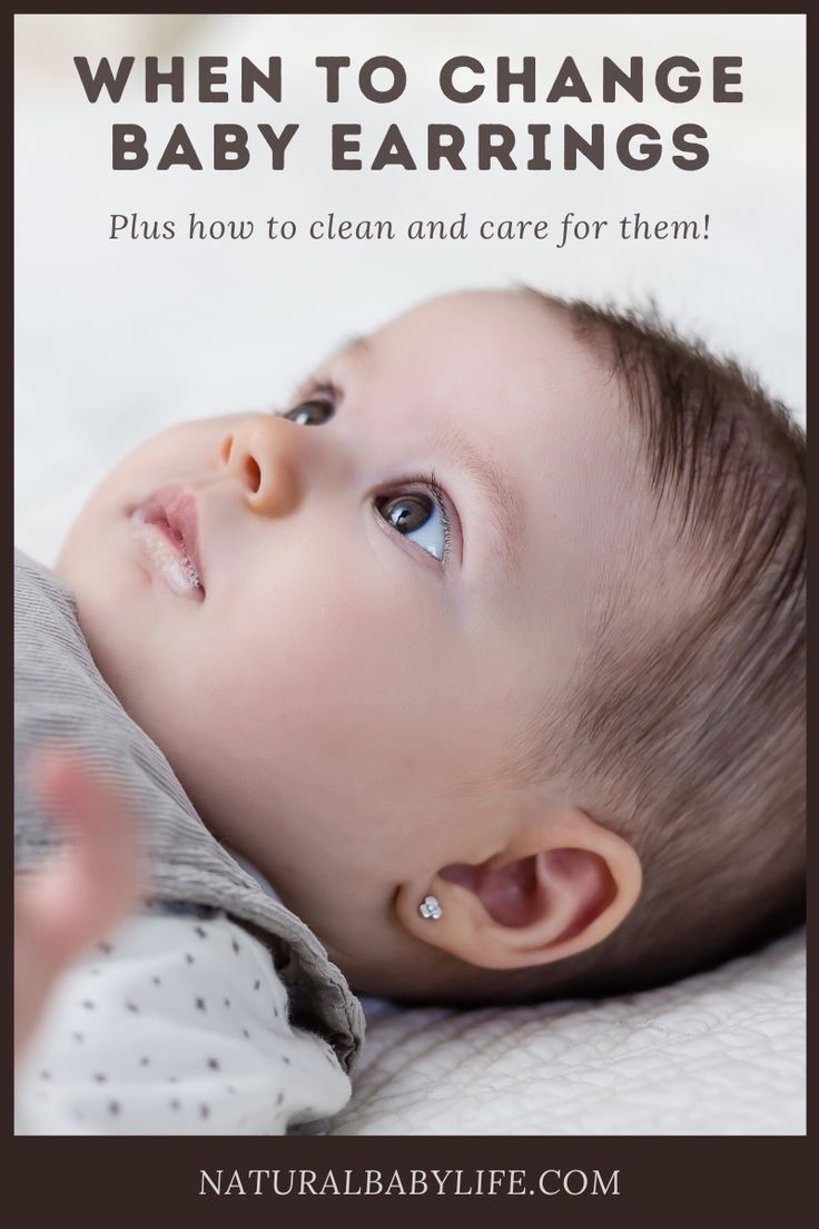 a baby with the words when to change baby earrings, plus how to clean and care for them