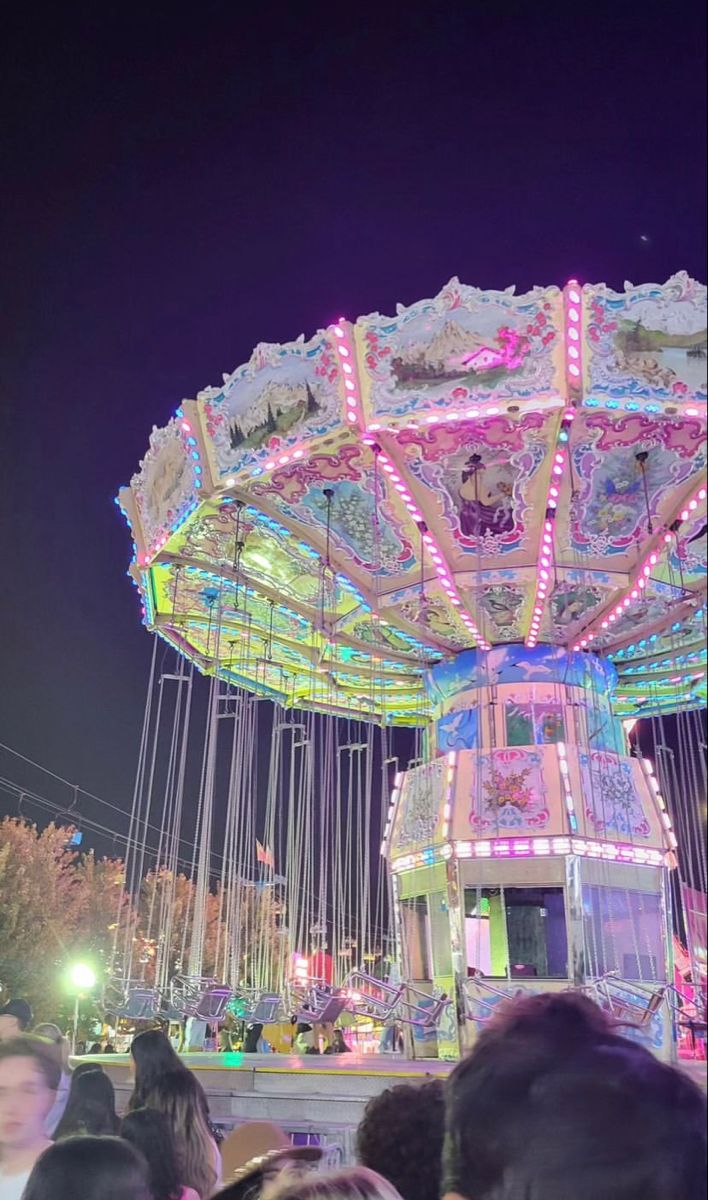 a carousel with lights on at night time