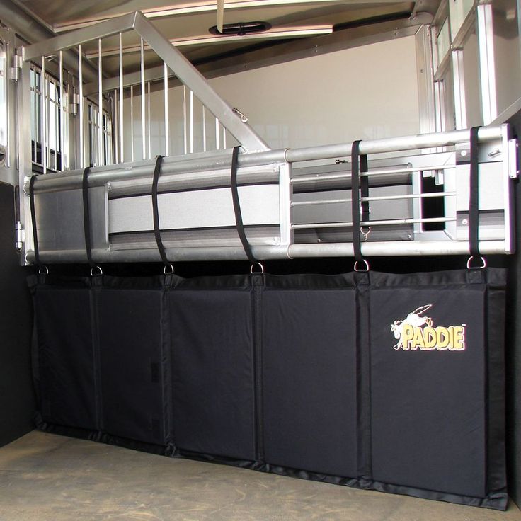 the inside of a horse stall with black dividers