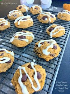 chocolate chip cookies with white icing on a cooling rack