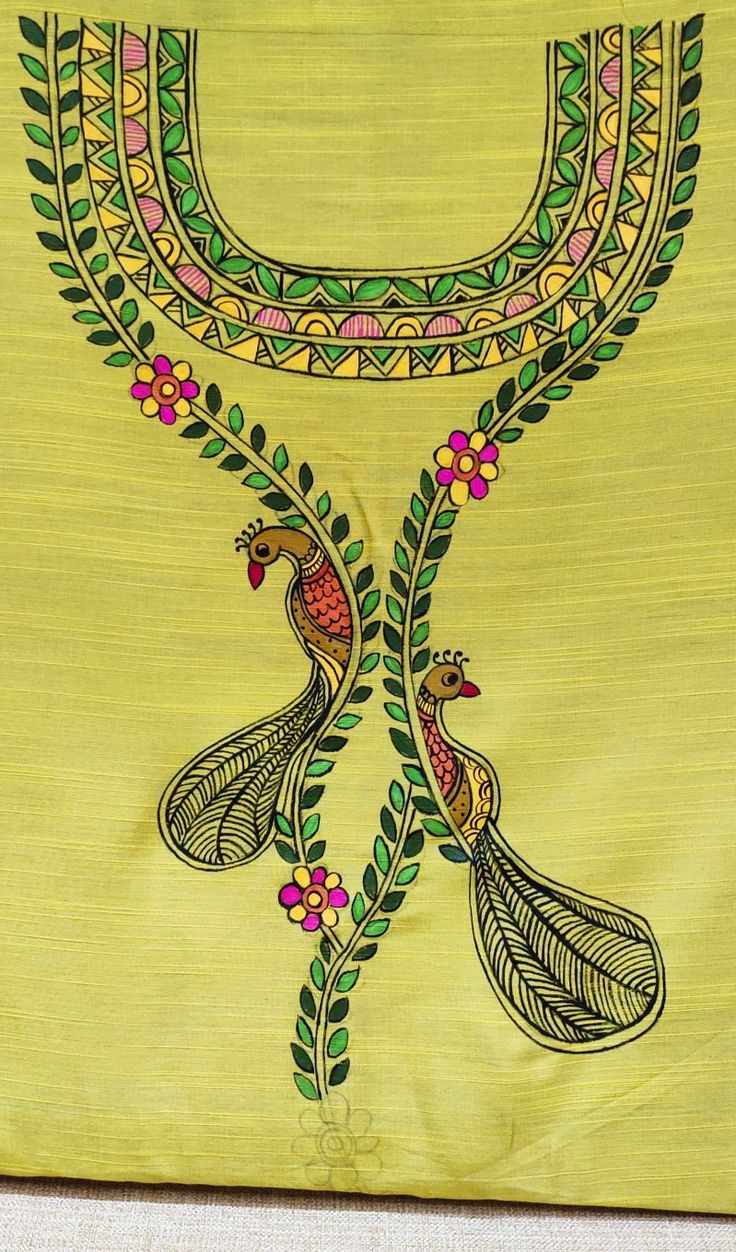 a yellow cloth with two peacocks on it