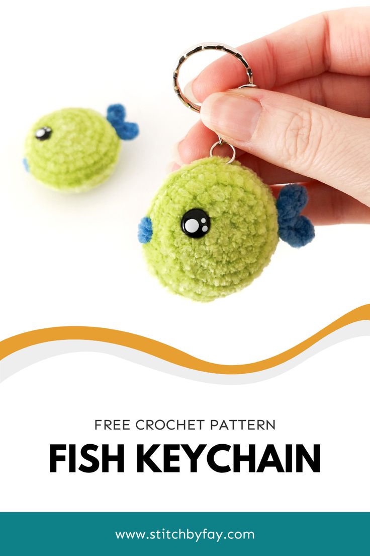 a hand holding a fish keychain with the text free crochet pattern