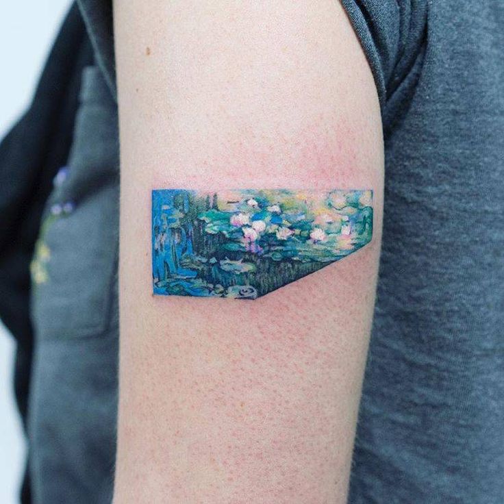 a person with a tattoo on their arm that has water lillies in the pond