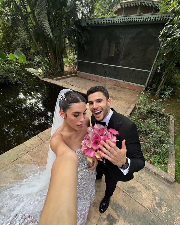 a bride and groom posing for a photo