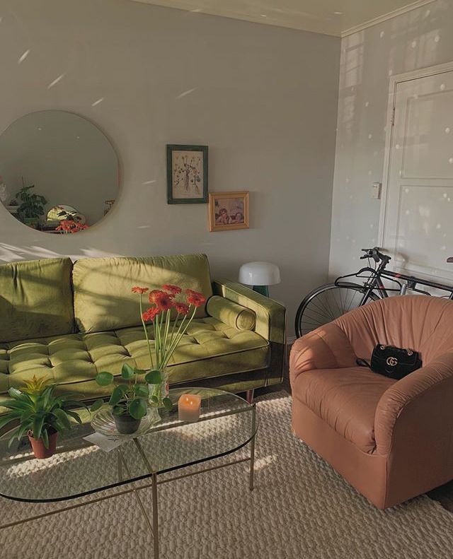 a living room filled with furniture and a bike parked in front of the couches