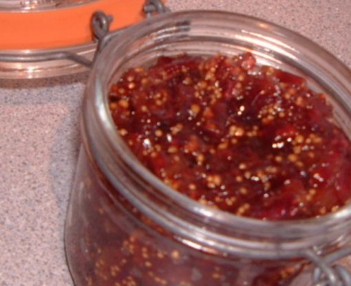 two jars filled with food sitting on top of a counter