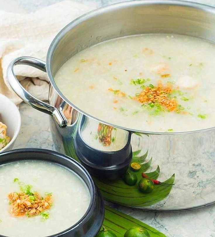 two pots filled with soup sitting on top of a table