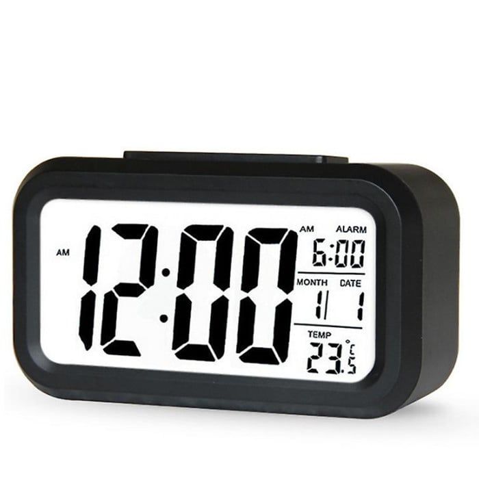 the alarm clock is black and has white numbers