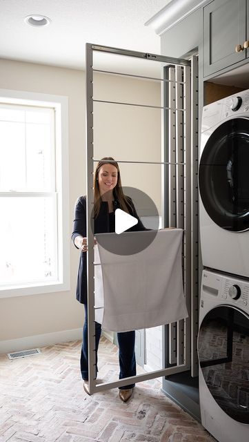 a woman standing in front of a washer and dryer