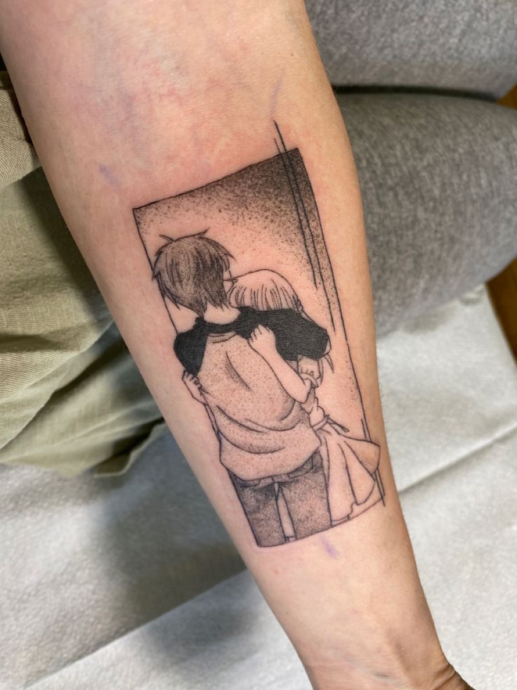 a person with a tattoo on their arm holding a cell phone and looking in the mirror